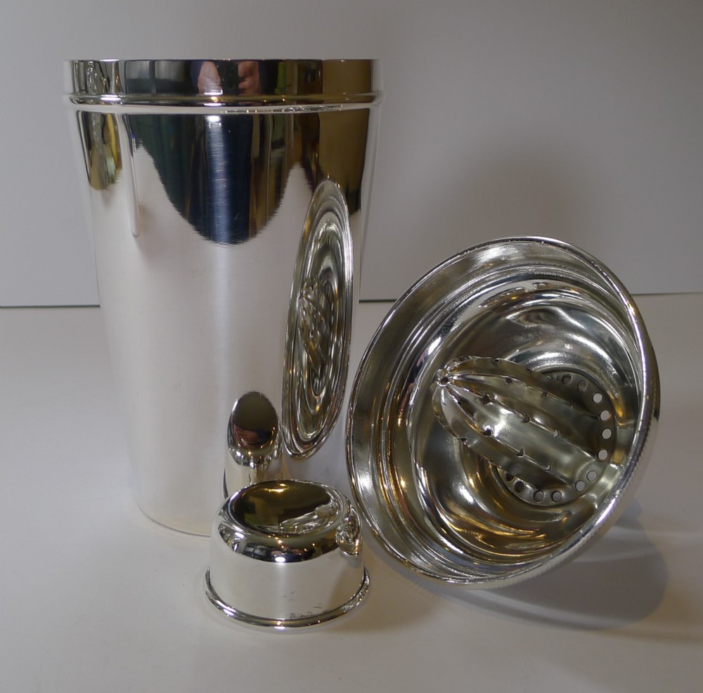 large silver plated cocktail shaker with integral lemon squeezer