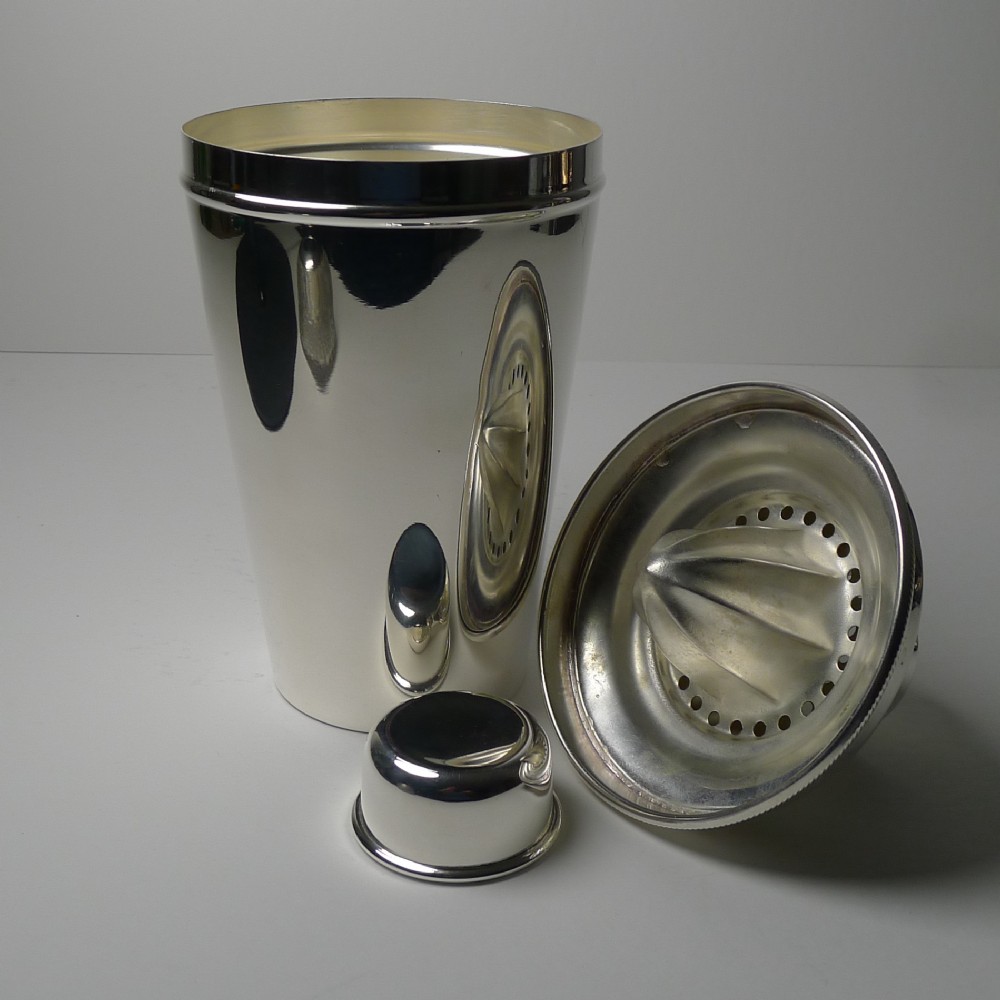 large silver plated cocktail shaker with integral lemon squeezer