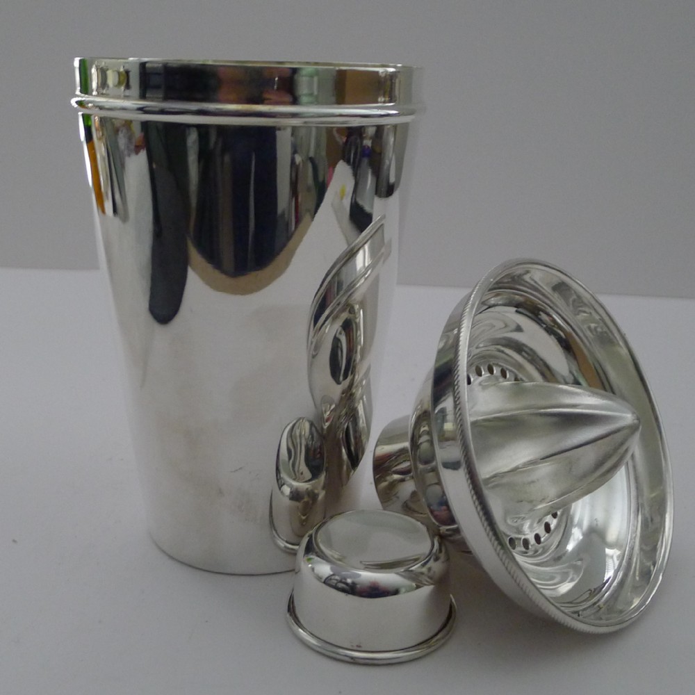 large silver plated cocktail shaker with integral lemon squeezer