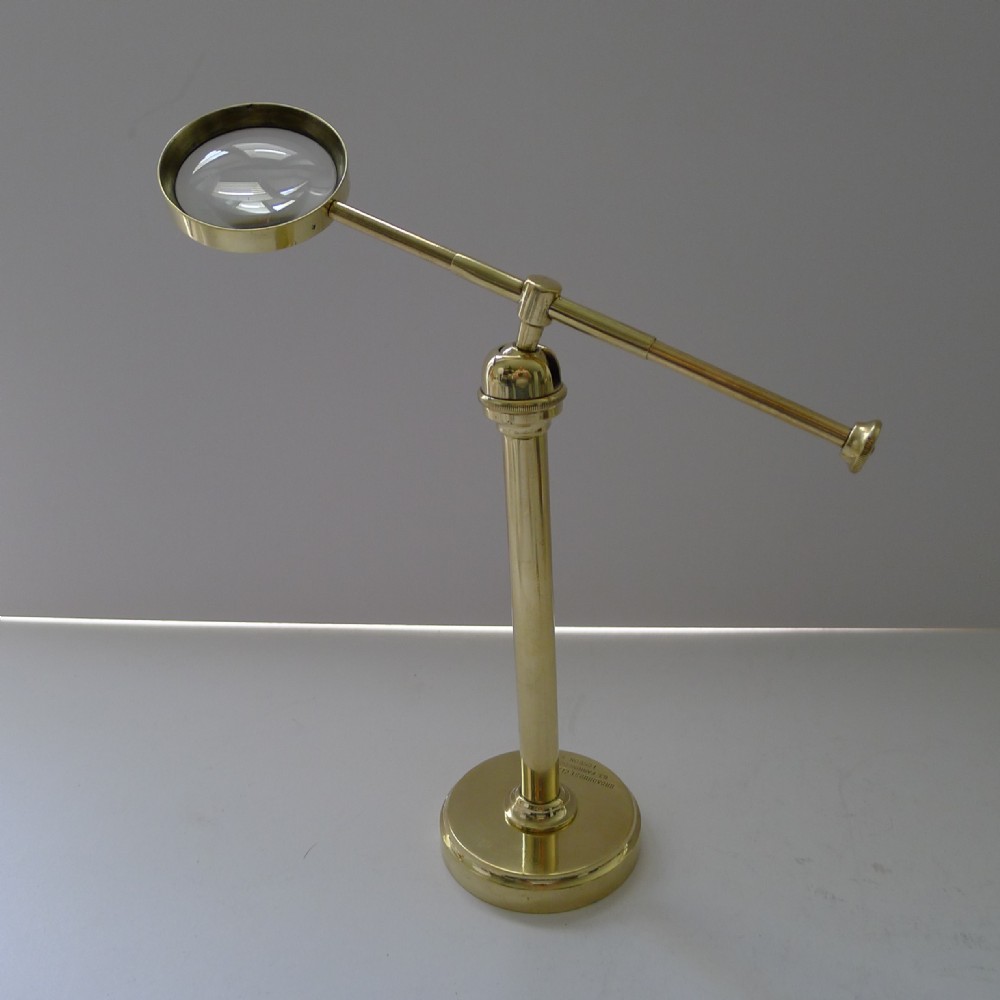 english brass pivoting magnifying glass on stand c1915 signed